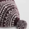 Cappello con pompon e motivo jacquard
