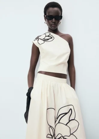 Top asimmetrico con ricamo floreale